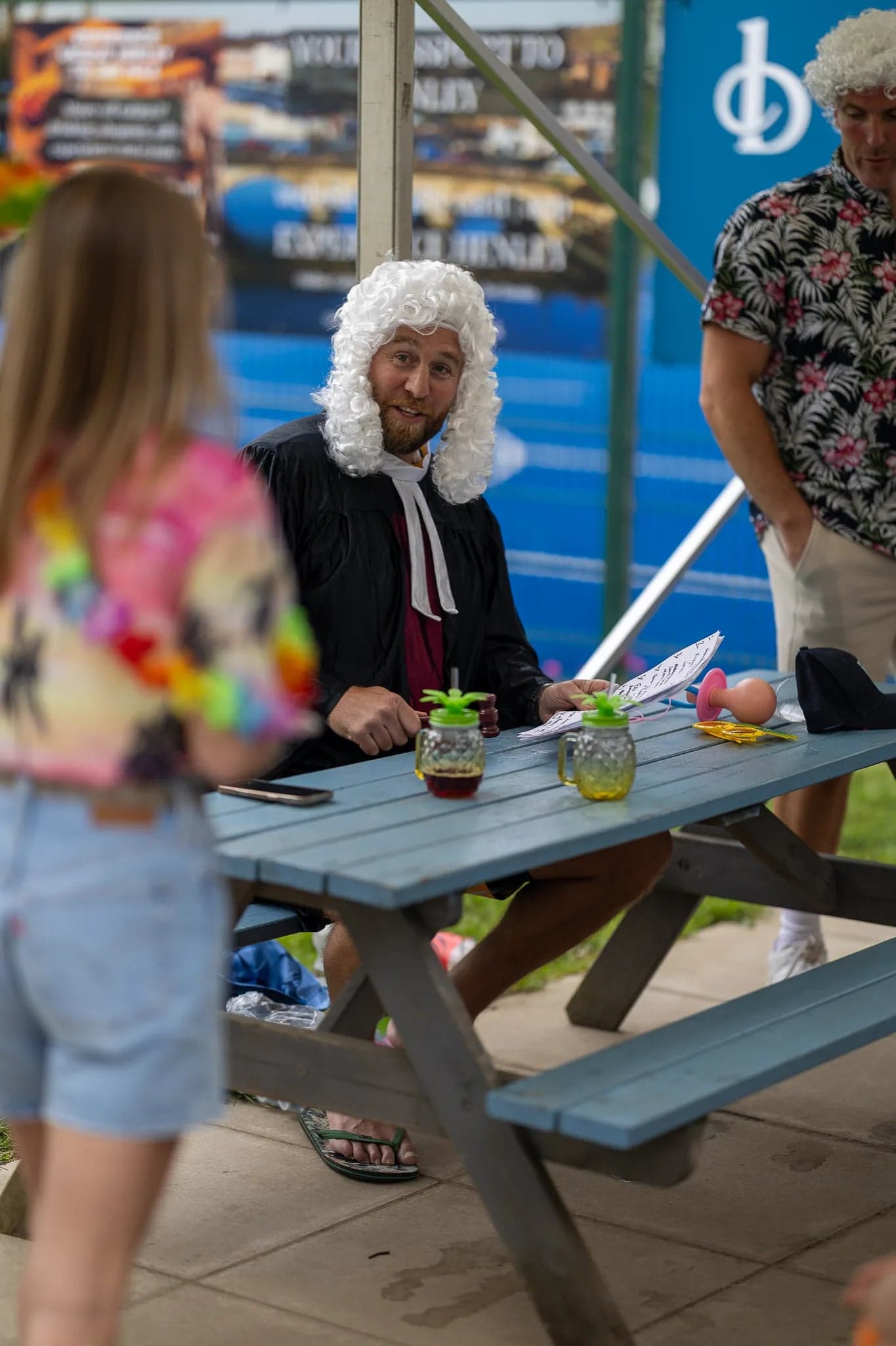 judge-wig fancy dress at picnic table